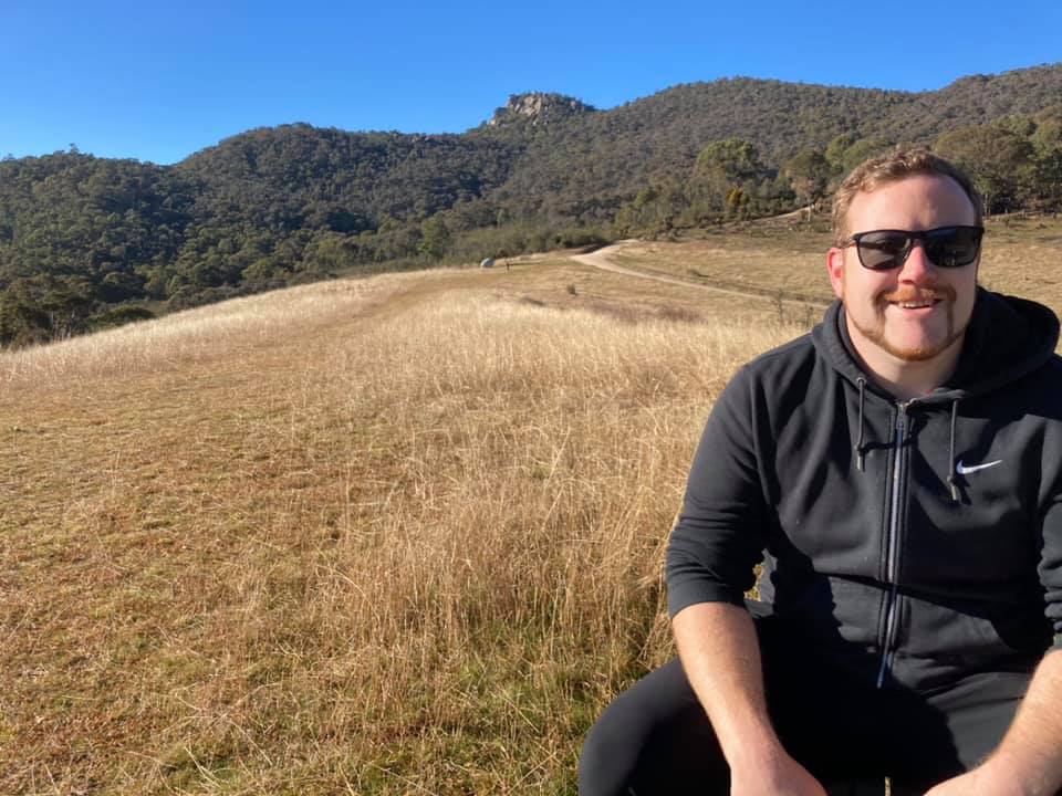 Jarryd smiling while sitting at a table